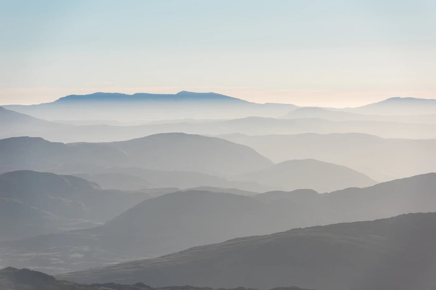 Layered mountain ridges fading into distant haze